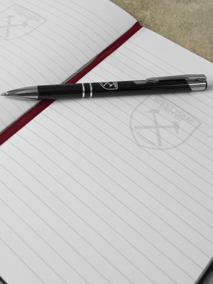 Inside ruled pages of notebook with West Ham United crest watermark and claret page marker