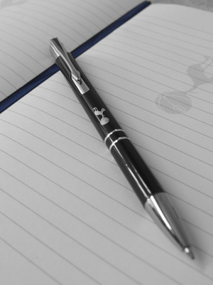 Ruled pages with Spurs crest watermark, Spurs pen, and navy page marker