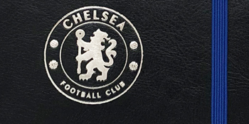 Silver crest on the front of the notebook