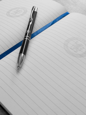 Inside of notebook with chelsea crest watermark and pen