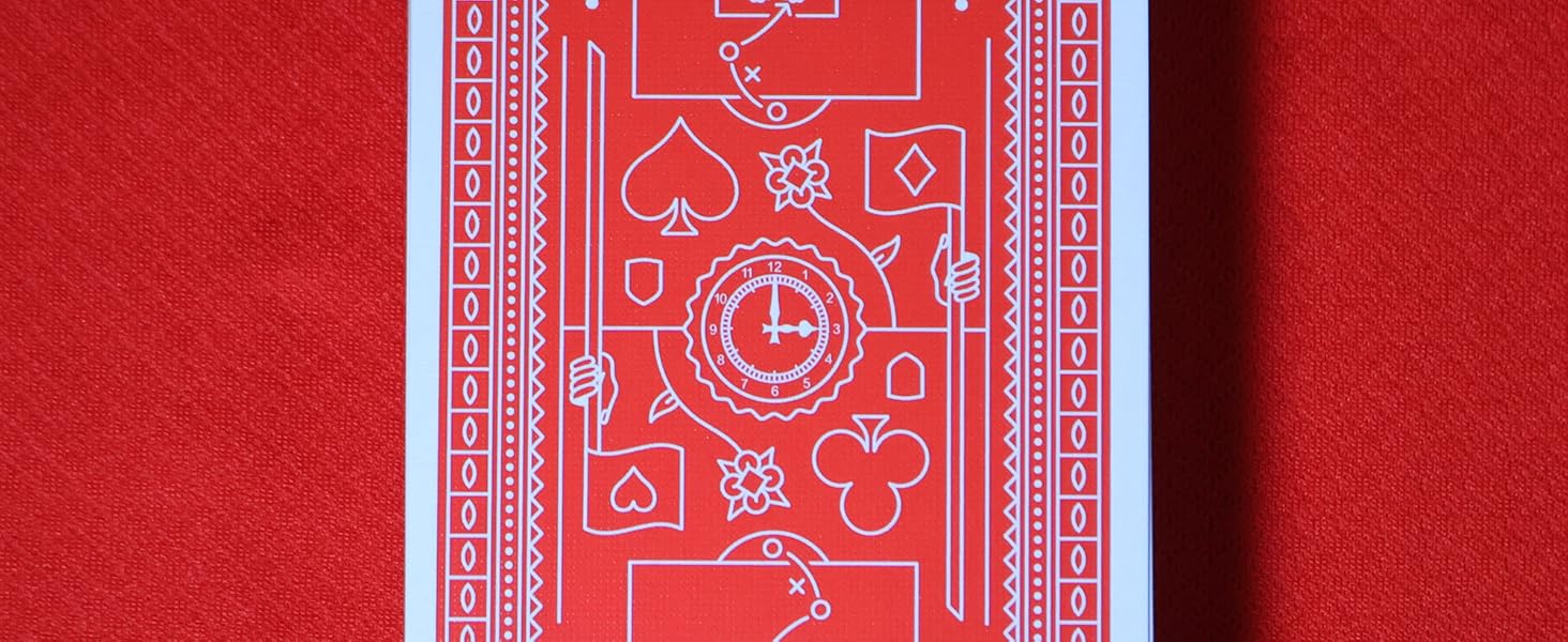 Red playing card face-up on red background. Card features white line drawings of sports fields, card suits, and a clock face.