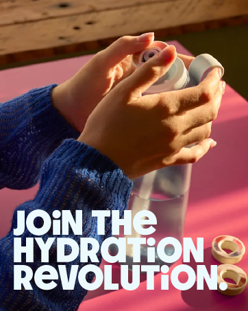 Hands holding a white reusable water bottle against a pink background. Text reads 'JOIN THE HYDRATION REVOLUTION' emphasizing eco-friendly hydration.