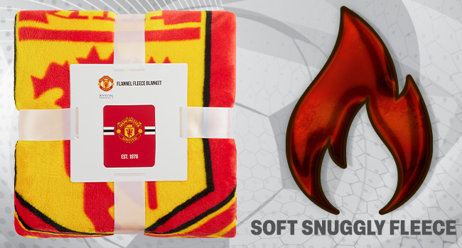 Yellow and red patterned fleece blanket with flame icon. Text indicates 'SOFT SNUGGLY FLEECE'. Product tag visible in corner.