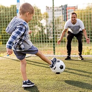 dada and boy playing football