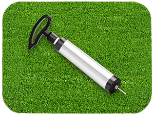 White cylindrical device shown in different positions on artificial grass surface, appearing to be some type of sports or outdoor equipment.
