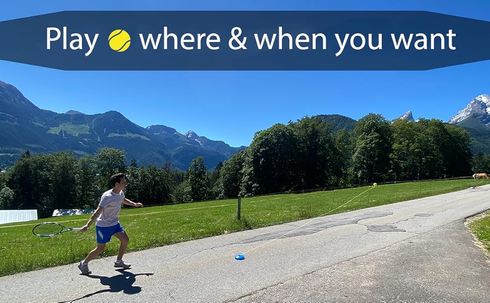 a man running down a road with a blue sky and mountains in the background.