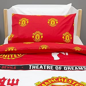 Collection of Manchester United branded bedding sets showing red and white duvet covers and pillowcases with team logo and 'THEATRE OF DREAMS' text.