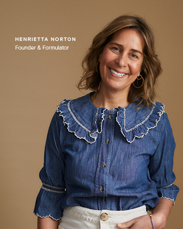 Denim button-up shirt featuring an oversized ruffled collar with white trim detail and three-quarter length sleeves.