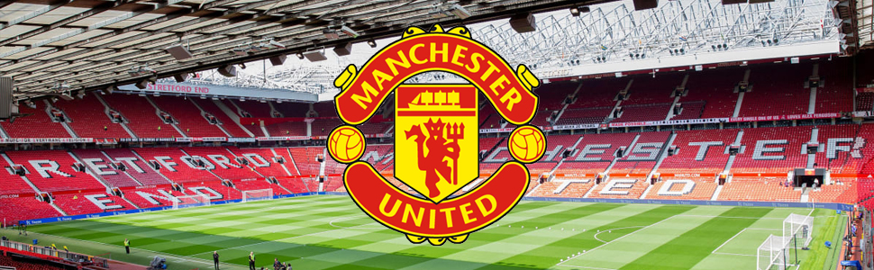 Wide view of Manchester United's Old Trafford stadium interior showing red seats, pitch, and Manchester United club crest.