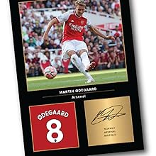 Soccer memorabilia display featuring a red jersey number 8, accompanied by action photograph and signature on gold-toned panel.